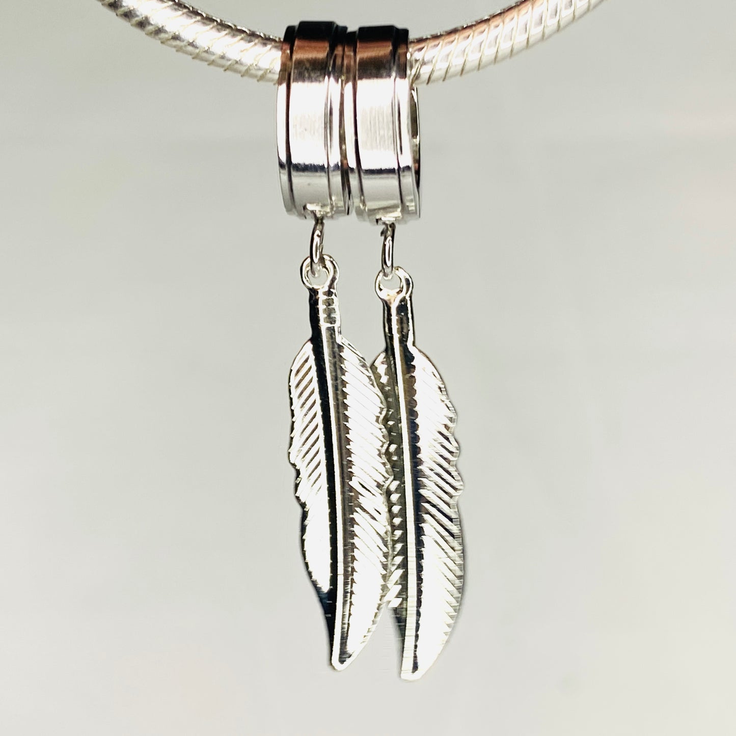 Boucles d'oreilles créoles en acier inoxydable avec plumes